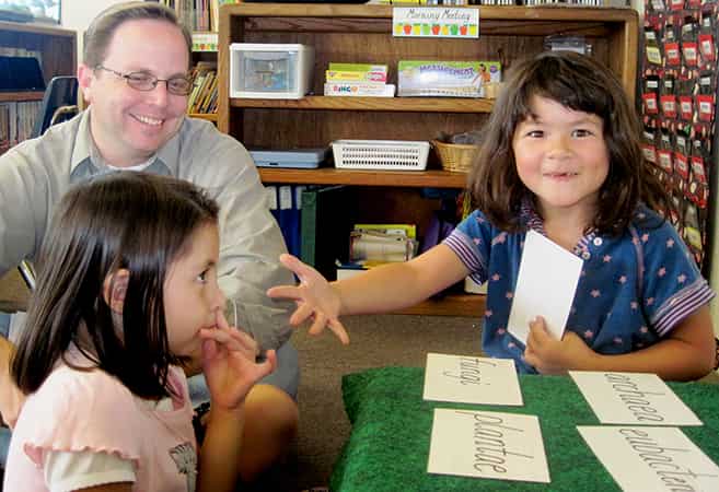 Elementary students engaging in a guided reading and language arts discussion with a teacher