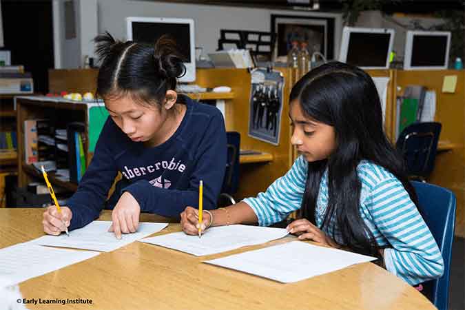 Students collaborating on writing activities during the WriteNow summer writing camp